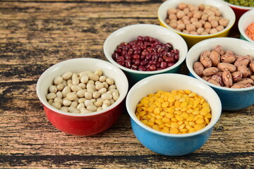 Assorted Legumes: beans and lentils variety on wooden background