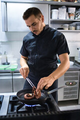 Young chef is preparing a typical with octopus dish of the restaurant. She brings to the table good and tasty cuisine