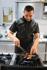 Young chef is preparing a typical with octopus dish of the restaurant. She brings to the table good and tasty cuisine