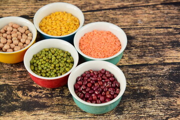 Assorted Legumes: beans and lentils variety on wooden background