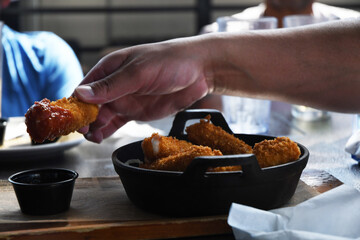 hand holding a chicken wing