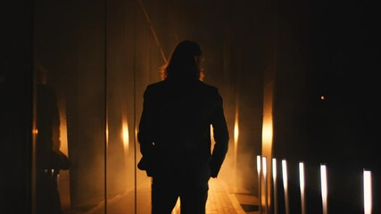 presentable man walks into the spotlights