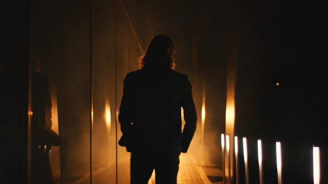 presentable man walks into the spotlights