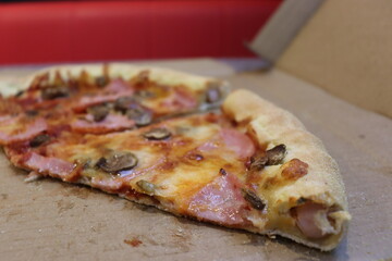 pizza slices with hod dog pipes in bar