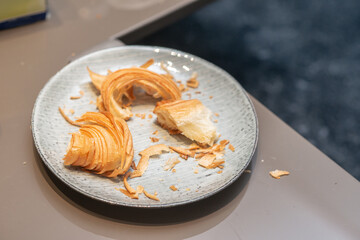 leftover almond  crossant on the plate