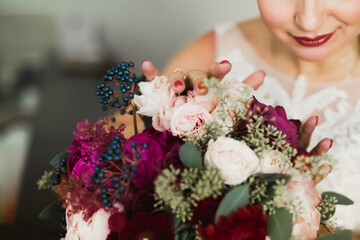 Luxury bride in white dress posing while preparing for the wedding ceremony