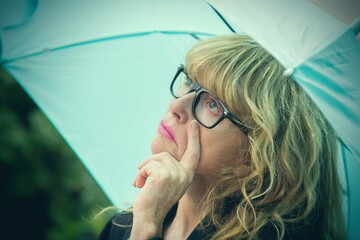woman in raincoat and umbrella in autumn
