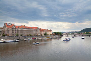 View of the river Vltava with cruising launches from the Čechův Bridge in Prague, Czech Republic.
