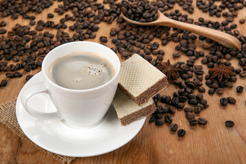 cup of coffee with cream with coffe beans still life