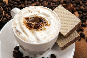 cup of coffee with whipped cream and cinnamon still life