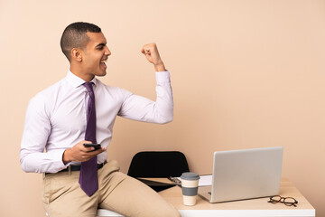 Young business man in a office making strong gesture