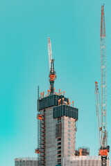 High-rise building in progress. Structural Engineering Background. Construction Site with Tower Cranes. Urban Photography.