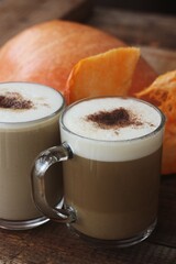 Pumpkin latte on a wooden table macro 