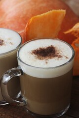 Pumpkin latte on a wooden table macro 