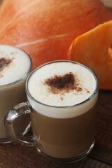 Pumpkin latte on a wooden table macro 