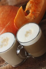 Pumpkin latte on a wooden table macro 