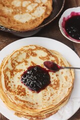 Delicious crepe and blackcurrant jam close up