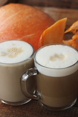Pumpkin latte on a wooden table macro 