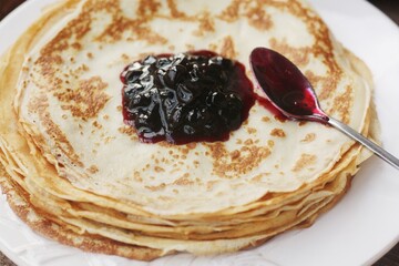 Delicious crepe and blackcurrant jam close up