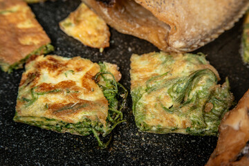 deep fried Egg with Climbing Wattle in the pan