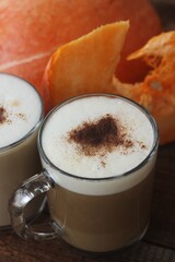 Pumpkin latte on a wooden table macro 