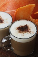 Pumpkin latte on a wooden table macro 