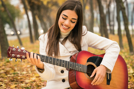 Female street musician portrait, fall scene