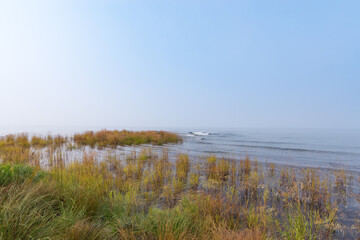 Eastern shore of Lake Baikal on a foggy day. Stones and grass