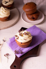 Homemade chocolate cupcakes decorated cheese cream and flowers