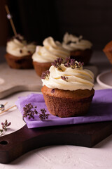 Homemade chocolate cupcakes decorated cheese cream and flowers