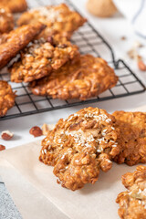Homemade oat cookies with various nuts and sesame seeds close-up. Tasty and healthy dessert, vegetarian and vegan food.