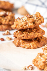 Homemade oat cookies with various nuts and sesame seeds close-up. Tasty and healthy dessert, vegetarian and vegan food.