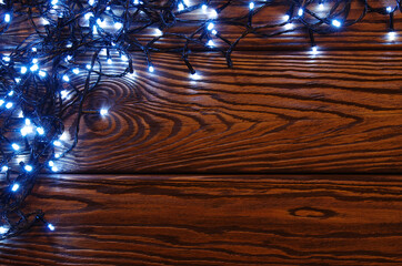 Сhristmas lights, background  ornaments on wood