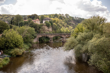 Fototapeta premium Panorama of the castle ruins Rudelsburg and Saaleck in the landscape and tourist area Saale valley on the river Saale near the world cultural heritage city of Naumburg, Saxony Anhalt, Germany