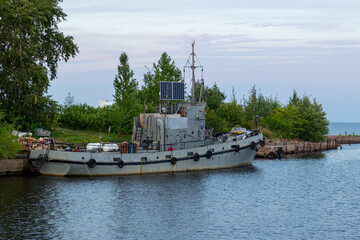 View on industrial ship equipped with electric solar panels. Twilight, low light