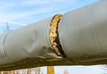 Damaged Central heating pipe. Break in the insulation of the heating main