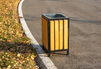 wooden urn in the Park, autumn foliage on the lawn