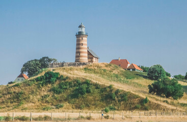 Lighthouse on a hill surrounded by houses in Denmark