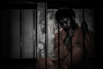 Asian man desperate at the iron prison,prisoner concept,thailand people,Hope to be free,Serious...