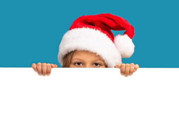 A little girl in a Christmas hat looks out from behind the background.