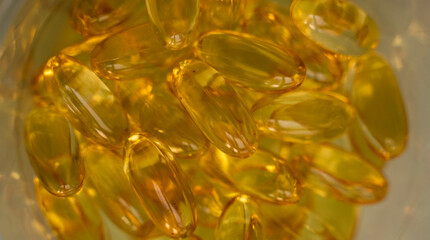 Extreme close up of fish oil orange yellow softgels capsules fish oil omega 3 or omega 6, omega 9,...