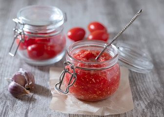 A spicy appetizer with garlic and horseradish in a transparent jar. Cold prevention. Preparation for the winter.