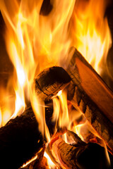 Flickering campfire embers dance softly in the vast night, casting a warm and soothing glow under...