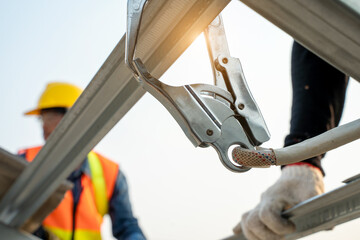 Safety line working at high place,Construction worker wearing safety harness and safety line...