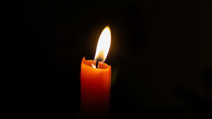 candle with flame in the dark