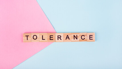 lettering of the letters tolerance on a blue and pink background, top view