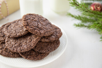Chocolate Chip Cookies on a White Plate with Milk Bottles. Christmas concept