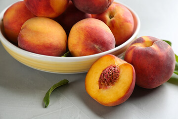Fresh sweet peaches on light table, closeup