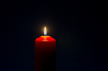 one red burning candle copy space