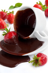 Chocolate fondue with fresh strawberries on the whte background